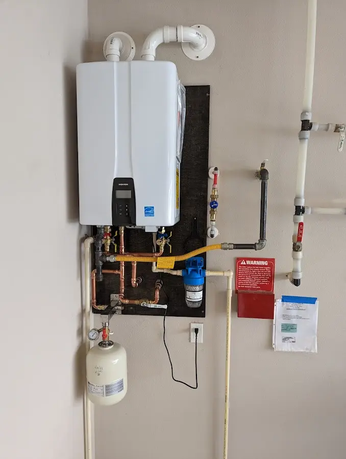 Professional plumber installing copper piping in a Lake George home